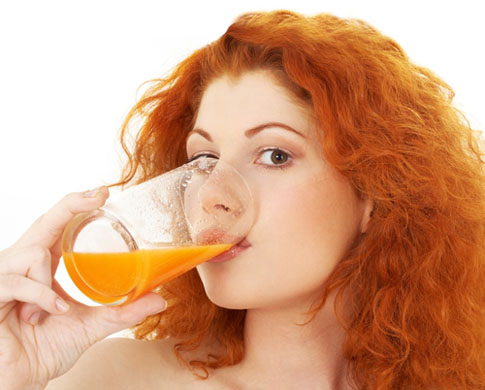 lovely redhead drinking orange juice